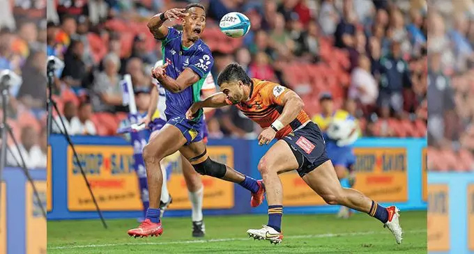 Swire Shipping Fijian Drua fullback Kitione Ratu offloads the ball after being caught by Brumbies fullback Tom Wright during their Super Rugby Pacific match at Suncorp Stadium, Brisbane, Australia, on April 9, 2022. Photo: Kev Nagle Photography