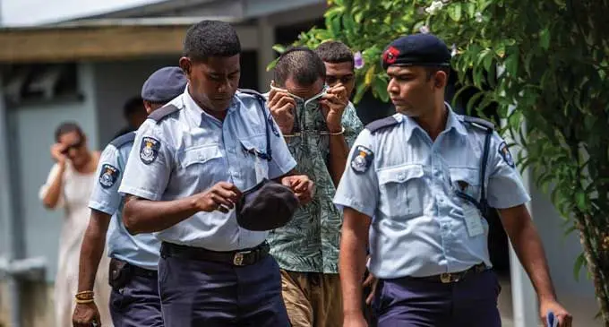 Alleged murder suspect Anare Vuli Ciliceva escorted by Police officers outside the Suva Magistrates Court on September 16, 2024. Photo: Leon Lord