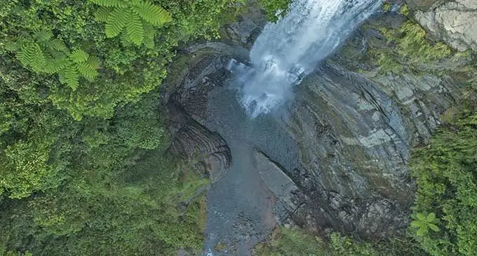 Hike through the rainforest with a village guide on the Coastal Waterfall Tour. Photo: National Geographic
