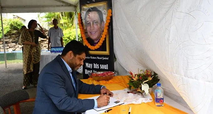 Attorney-General and Minister for Economy, Aiyaz Sayed-Khaiyum signs the condolence book at the memorial for the late Kishore Govind.  Photo: DEPTFO News