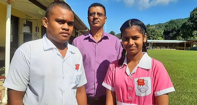 Newly inducted head boy Fred Wesley and head girl Yaadavi Naicker with their headteacher Bhagwan Dutt Lal during the prefect induction at Vunika Primary School on April 29, 2022.