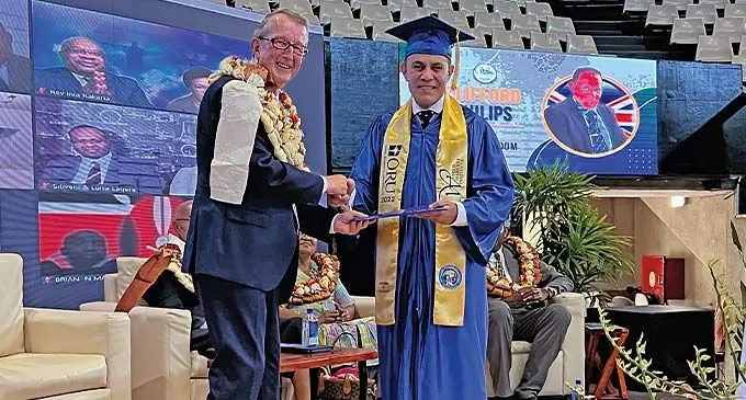 Clifford Phillips receiving his Diploma Certificate from Pastor David Collins. Photo: Viliame Tawanakoro