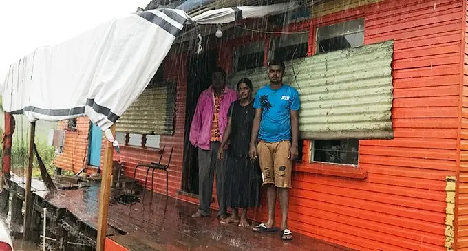 Pravin Kumar (left) with his wife Kushma Kumari and son Shamal Kumar watching the rain from outside the house in Tabia, Labasa on January 17, 2020.  Photo: Shratika Naidu