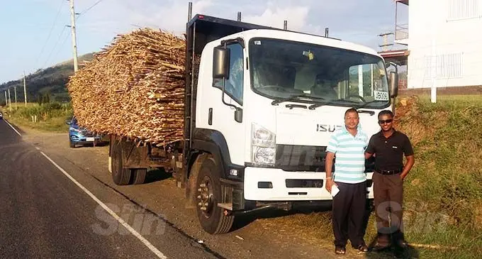 Rakiraki businessman and sugarcane farmer, George Shiu Raj (left), with one of the first of 22 cane trucks he plans to buy. Photo: Susana Tuilau.