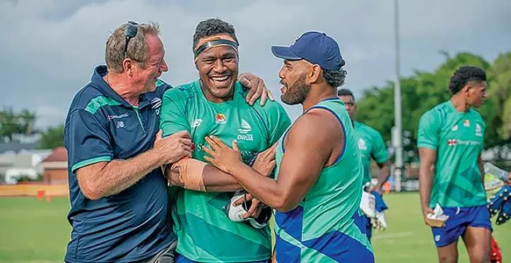 Labasa-born Swire Shipping Fijian Drua lock Leone Rotuisolia (middle) is congratulated by head coach Mick Byrne (left) and Haereiti Hetet on his 24th birthday at Lennox Head in New South Wales, Australia on February 21, 2022 Photo: Fijian Drua Media