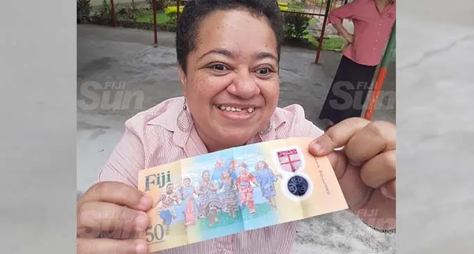 Vereonica Narayan, a teacher at the Fiji Society for Blind school feels the Braille feature on a new Fiji $50 note, making it the first Fijian currency note to feature Braille. Photo: Ronald Kumar