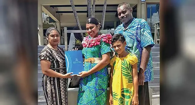 Vilimaina Naivou Sokoverata with her sister Temalesi and father Amani with Fiji National University lecturer Saleshni Nair at the Fiji National University Namaka Campus in Nadi on December 13,2022.