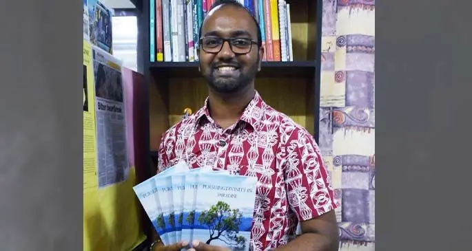 Prashneel Goundar with his book Pursuing Divinity in Paradise. Photo: Fiji National University