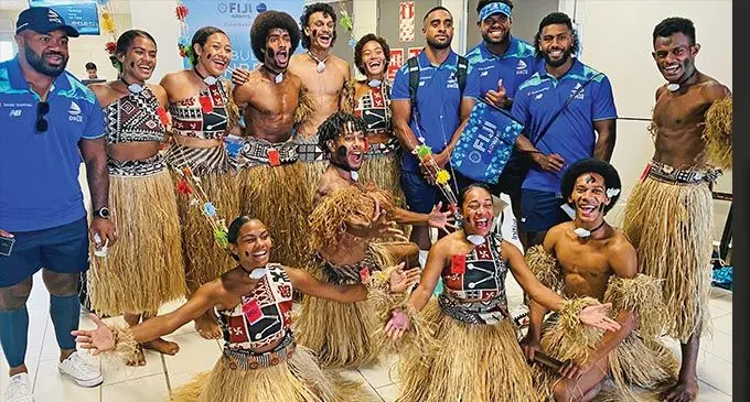 Fijian Drua players Kemu Valetini, Chris Minimbi and Frank Lomani with the entertainers at Nadi International Airport on April 14, 2023. Photo: Leon Lord
