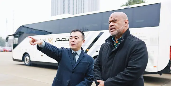 Bonluck Bus & Coach Group executive director Ken Lee (left) with Rosie Travel Group general manager Eroni Puamau at the Bonluck Bus & Coach Group factory in China.