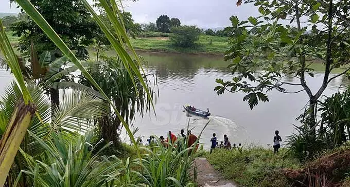 Villagers stood by the riverbank to watch the Police officers transport the body of Mitieli Namuka across the river to the mortuary in Wainibokasi. Photo: Shalveen Chand