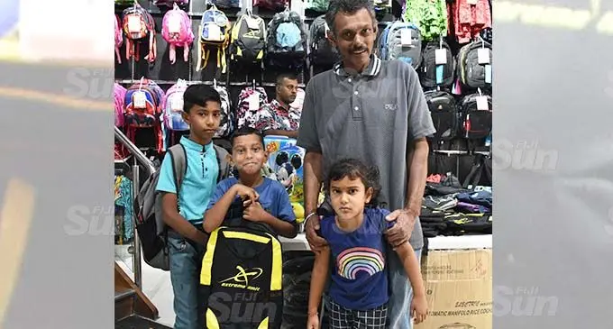 Sunil Sharma with his three children, from left: Shohrat Sharma, Nishal Sharma and Aniya Sharma at Meenoos Store in Nadi. Photo: Mereleki Nai