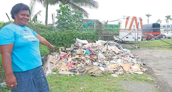 Vendor, Luisa Vosa points at the pile of rubbish that has been there for almost a month now at  Daniva road in Valelevu.  Photo: Kelera Sovasiga