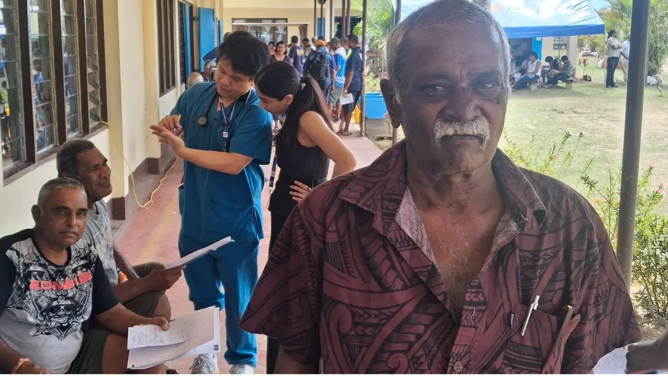 70-year-old Narayan Gounder (brown shirt) with patients. Photo: WAISEA NASOKIA