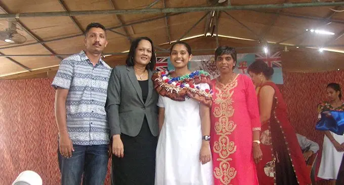 Headgirl Palvi Dewan with her parents and the Minister for Education, Heritage and Arts, Rosy Akbar.