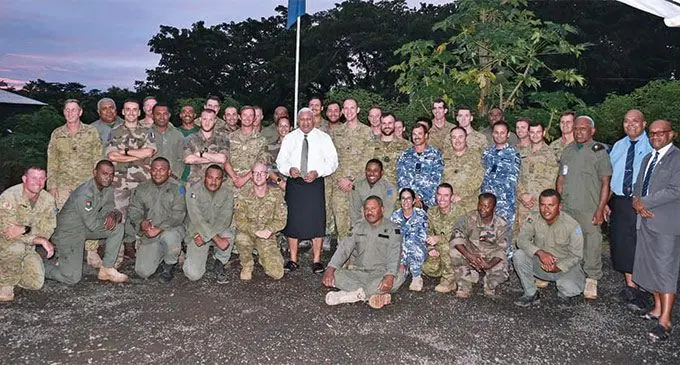 Prime Minister Voreqe Bainimarama with members of the Australian Defence Force, New Zealand Defence Force, French Army and Republic of Fiji Military Forces who are working on the rebuilding of the damaged buildings in Lekutu Secondary School.. Photo: Office of the Prime Minister