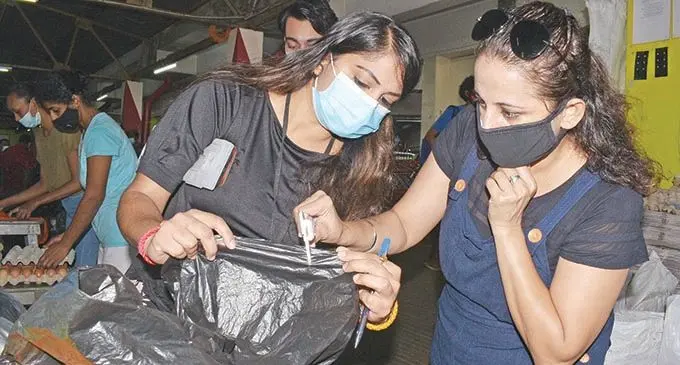 Ministry of Environment, environment officer Dipika Sharma (left) with Director Environment Sandeep Singh checks the plastic thickness used by market vendors at the Suva market on September 24, 2021. Photo: Ronald Kumar