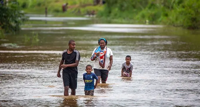 Residents of Wainadoi Kasinaura Road seen crossing after torrential rain caused the closure of the roads on October 21, 2022. Photo: Leon Lord