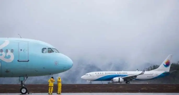 A plane lands at Wudangshan Airport in Shiyan, central China's Hubei Province, March 29, 2020.  (Photo by Tao Debin/Xinhua)