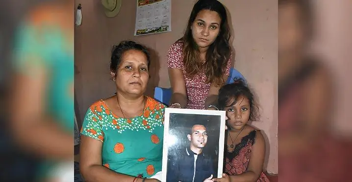 From left; Nilam Sharma and her daughters Shivani Sharma, middle, and Steffi Sharma with the photo of Kunnal Nair at their home at Korovuto, Nadi. Photo: Mereleki Nai