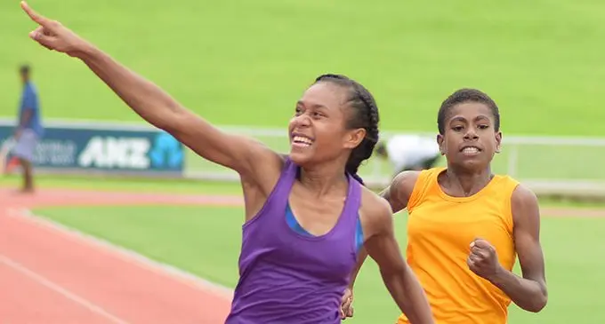 Roselyn Rakai  (middle) celebrates as she won sub-junior girls 100meters final during Dilkusha Methodist High School inter-house competition at National Stadium. Photo: Ronald Kumar. 