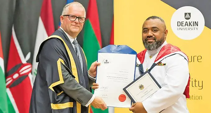 Captain Timoci Natuva (right) graduated with Distinction from Deakin University with a Master of National Security and Strategic Studies. Photo: RFMF Naval Division
