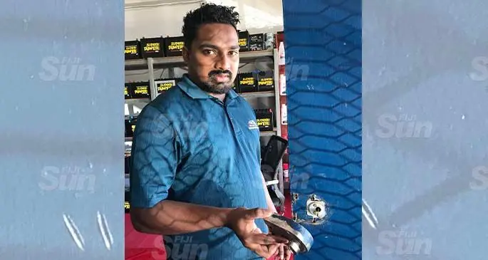 Super Batteries PTE Limited office administrator Akshay Kumar showing the damaged door. Photo: Waisea Nasokia