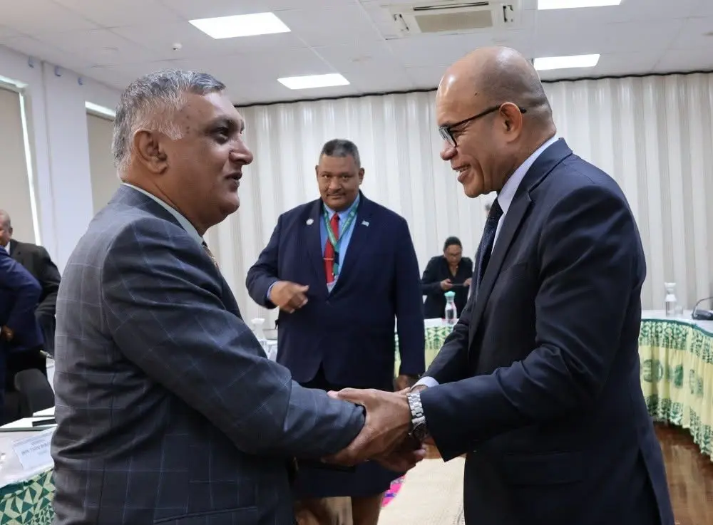 Independent Member of Parliament Virendra Lal and Permanent Secretary for the Office of the Prime Minister, Dr Lesi Korovavala, shake hands after the session.