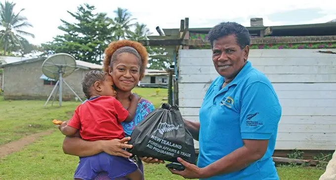 Timaima Dimulo and her son, Emosi Mataibau with their dignity kit from Empower Pacific’s Ana Radrekusa. Photo: Josefa Babitu 