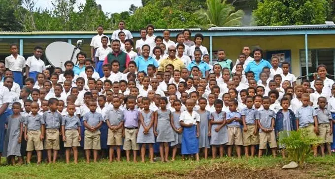 Minister for Infrastructure, Meteorological Services, Lands and Mineral Resources, Jone Usamate (in yellow) with staff and students of Naceva District School on July 5, 2022. Photo: DEPTFO News