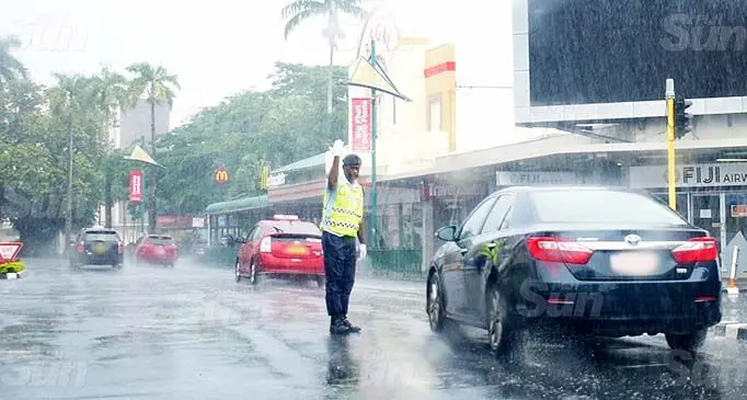 A Police officer fighting the rain to control traffic in Suva on September 17, 2020. Photo: Ronald Kumar