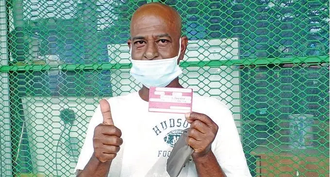 Vimal Vikash holds his vaccination card after receiving his booster shot at the Kshatriya hall in Lautoka on January 5, 2022. Photo: Salote Qalubau