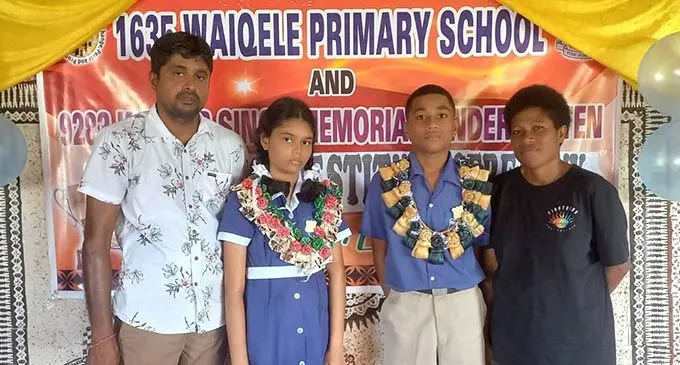 Gyanendra Kumar with his daughter the head girl, Arshiya Kumar and head boy Josefa Tui with his mother Diwalesi Tamaiuca during the prefects’ induction at Waiqele Primary School in Labasa on May 5, 2022. Photo: Waiqele Primary School.