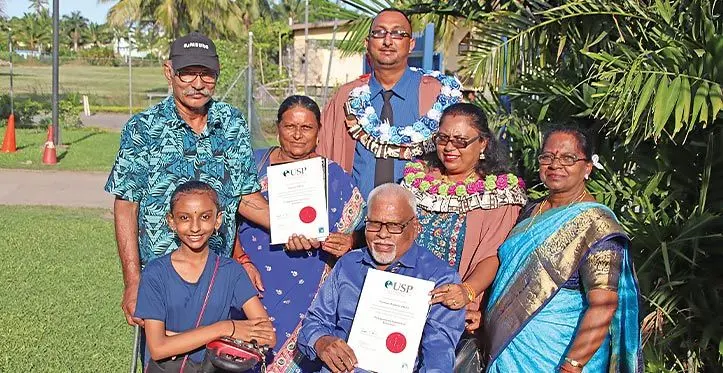 University of the South Pacific graduates (with graduation gowns) Rajneel Singh and Poonam Anjli with their family after the USP graduation ceremony at the Vodafone Arena on March 30, 2023. Photo: Josefa Babitu