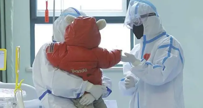 A medical staff holds a 14-month-old baby recovered from novel coronavirus pneumonia before his discharge from the Wuhan Children's Hospital in Wuhan, capital of central China's Hubei Province, Feb. 13, 2020. (Wuhan Children's Hospital/provided to Xinhua)