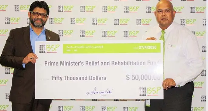 From left: Attorney-General and Minister for Economy Aiyaz Sayed-Khaiyum and BSP Country Head Haroon Ali hold the cheque for $50,000 donated by BSP for Tropical Cyclone Harold rehabilitation.