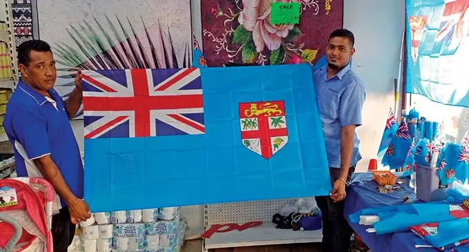 Bargain Box Bila Street Branch staff Rupeni Teki (left) and Manager Shivnesh Gounder showcase the items that will be sold to Drua supporters. Photo: Salote Qalubau