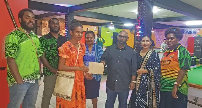 University of the South Pacific Vanuatu Student Association Independence Chair, Ms Aileen Iopa (third from left) receiving the donation envelope from Mr Nausheem Ali (fifth from left) on July 20, 2022. Photo: Jone Salusalu