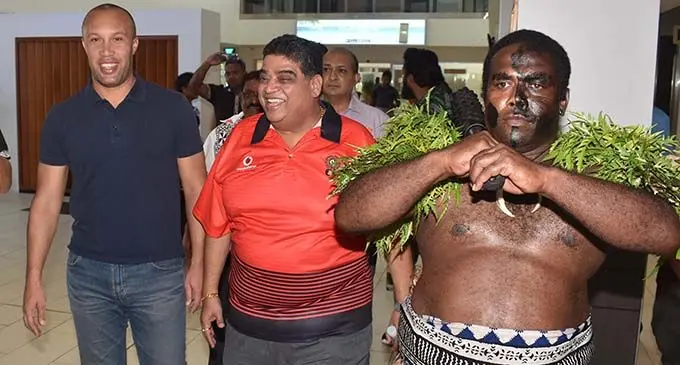Mikael Silvestre (left) is escorted  by a traditional warrior with Fiji Football Association president Rajesh Patel as he arrives at Nadi International Airport on February 27, 2019. Photo: Waisea Nasokia 