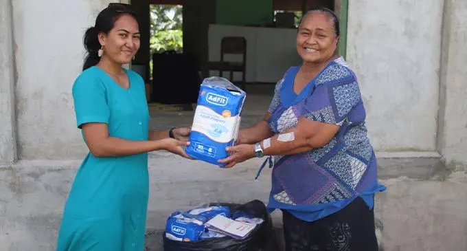 Empower Pacific’s Patricia Vilisoni (left) hands over a set of adult diapers to Tiu Sagaitu in Oinafa Village, Rotuma. Photo: Josefa Babitu