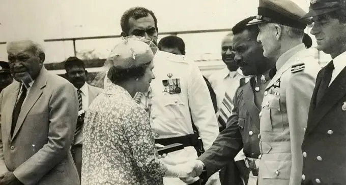 Queen Elizabeth II handing over the gift to WO1 Jone Sokovata at the Nadi Airport before returning to the United Kingdom in 1982.