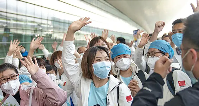 Medics from north China’s Tianjin Municipality wave goodbye before their departure in Wuhan, after completing the task, March 17, 2020.