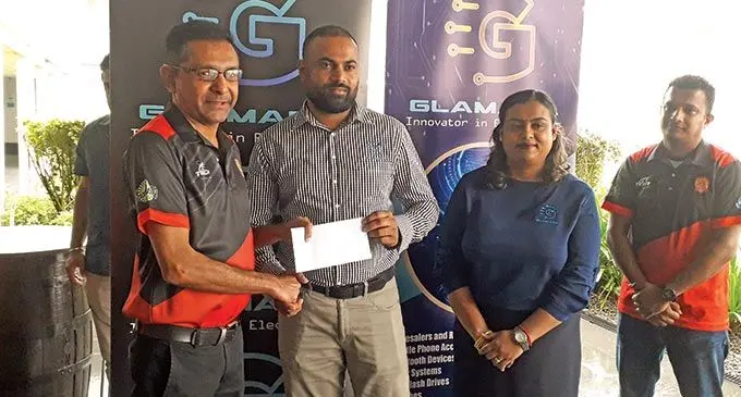 Rewa Football Association senior vice president Sanjay Patel (first from left) receives the cheque from Glamada Investments managing director Jaynesh Narayan at the Holiday Inn, Suva, on June 16, 2022. Photo: Sereana Salalo
