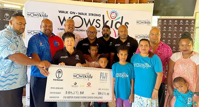 Fiji Rugby Union senior management staff led by Board of Trustees member Jenny Seeto (third from left) with Walk On Walk Strong (WOWS) children and families during the cheque presentation in Suva on December 13, 2023. Photo: Sereana Salalo