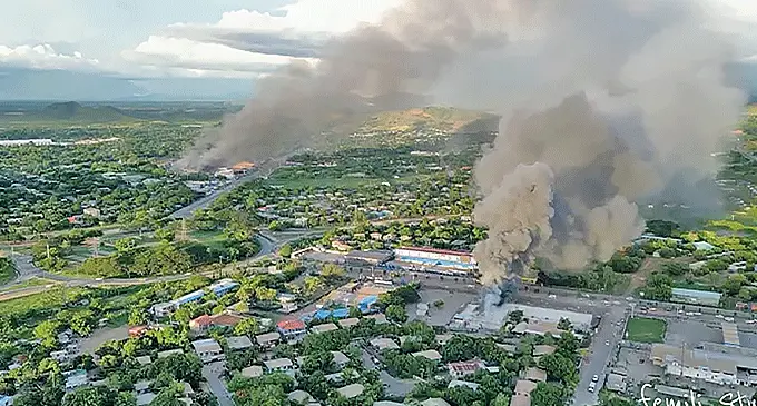 An aerial view of smoke billowing from buildings set alight during Wednesday’s unrest in Port Moresby, Papua New Guinea.
