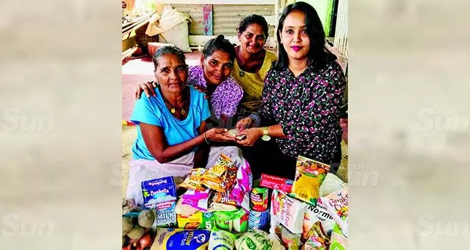 Fiji Sun Labasa Office staff member Ashmita Prasad (right) handing over groceries and cash to Ms Parvati (left) and her daughters Reshma Singh and Sanjeeta Singh at their home in Siberia, Labasa on August 6, 2020. The financial assistance was sent by an Australian citizen. Photo: Shratika Naidu
