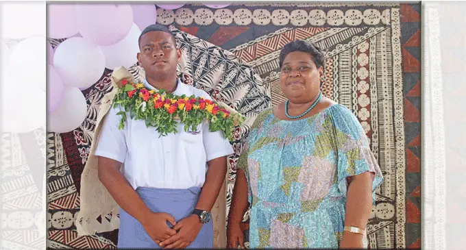 Head boy Joshua Biudole, with his mother Ane Biudole. The remains of the burnt house at Davuilevu Settlement.