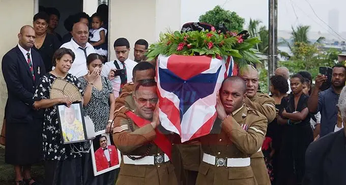 Fijian British Army soldiers carry the casket of Corporal Ifereimi Vasu, as his wife, Marian and daughter, Kiti look on at Suvavou Village on December 17, 2019. Photo: Ronald Kumar