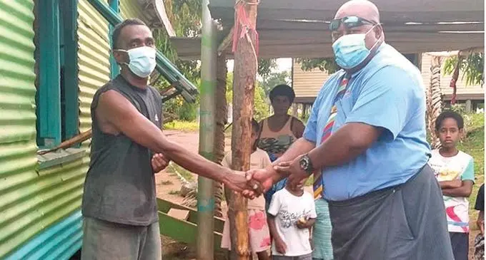 Roko Tui Bua Waisake Tuisese hands over 10 buckets containing wash kits to Naivaka Village Headman Aporosa Momo on behalf of Wildlife Conservation Society.