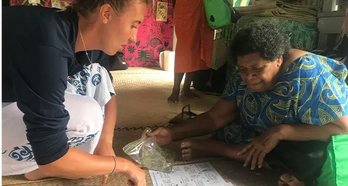 Seagrass researcher Carrie Wentzel showing her findings to 71-year-old, Rusila Tauyavu of Muanaicake village in Fulaga. Photo: Kelera Sovasiga